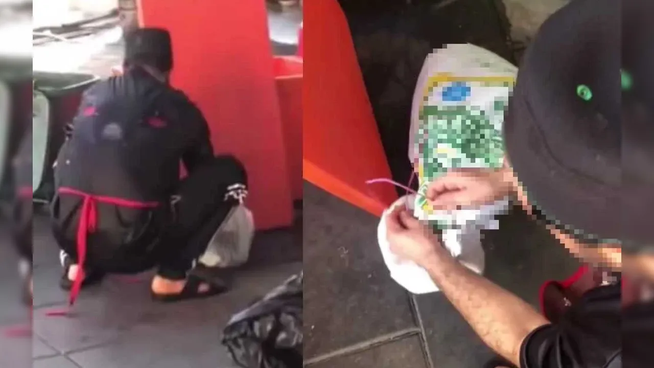 Tangkap layar video tular memaparkan pekerja restoran berkenaan bertindak memasukkan seekor kucing ke dalam guni._SINAR HARIAN