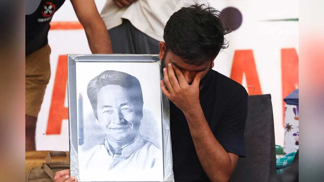 FILE PHOTO: Abhijeet Dipke, head of the Cockroach Janta Party (CJP) reacts as he holds a picture of Sonam Wangchuk, an Indian education reformer who had been on a hunger strike, after Wangchuk was taken to a hospital by authorities during a sit-in protest called by the CJP to demand the resignation of Indian Education Minister Dharmendra Pradhan, as Dipke sits on an indefinite hunger strike, at Jantar Mantar in New Delhi, India, July 18, 2026. REUTERS/Bhawika Chhabra/File Photo