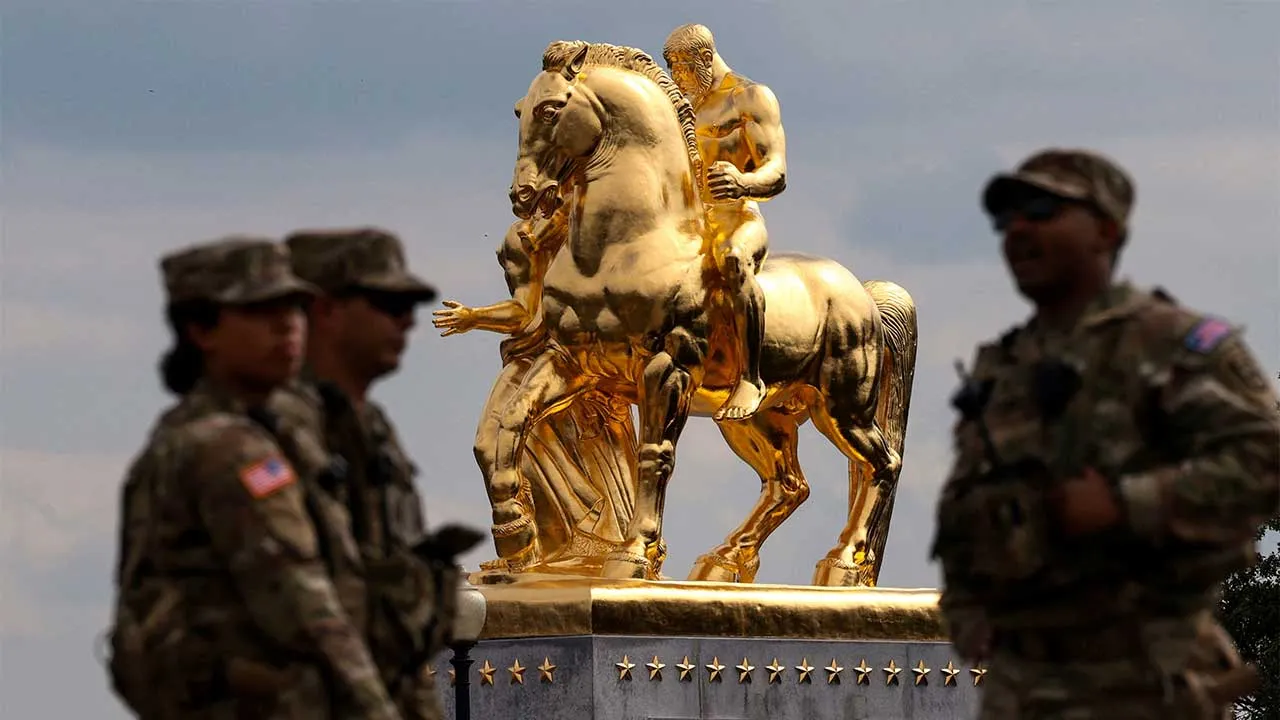 U.S. National Guard troops stand near the statue "Sacrifice", one of the "The Arts of War" equestrian statues flanking Arlington Memorial Bridge, which were recently regilded amidst ongoing construction projects in Washington, D.C., U.S., July 29, 2026. REUTERS/Evelyn Hockstein