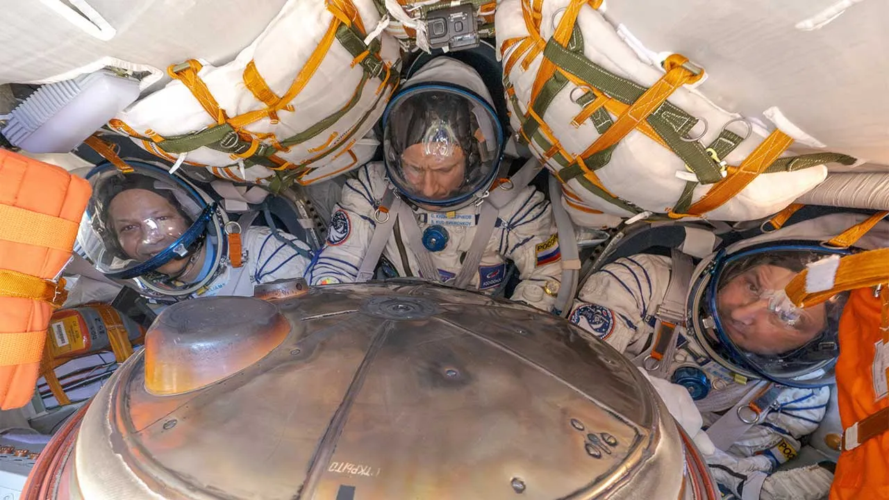 The International Space Station (ISS) crew of NASA astronaut Christopher Williams, Roscosmos cosmonauts Sergey Kud-Sverchkov and Sergey Mikaev react inside the Soyuz MS-28 space capsule after a landing in a remote area near Zhezkazgan, Kazakhstan, July 26, 2026. NASA/Bill Ingalls/Handout via REUTERS ATTENTION EDITORS - THIS IMAGE HAS BEEN SUPPLIED BY A THIRD PARTY. MANDATORY CREDIT.