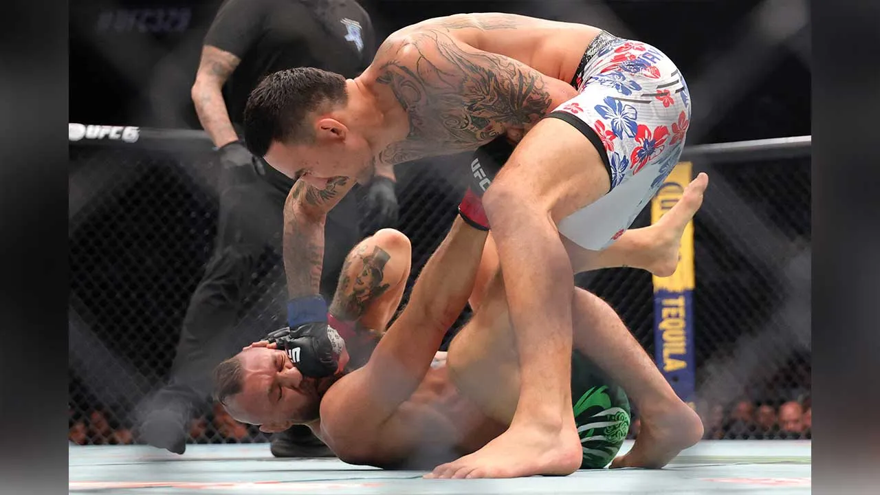Jul 11, 2026; Las Vegas, Nevada, USA; Conor McGregor (red gloves) fights Max Holloway (blue gloves) in a welterweight bout during UFC 329 at T-Mobile Arena. Mandatory Credit: Mark J. Rebilas-Imagn Images