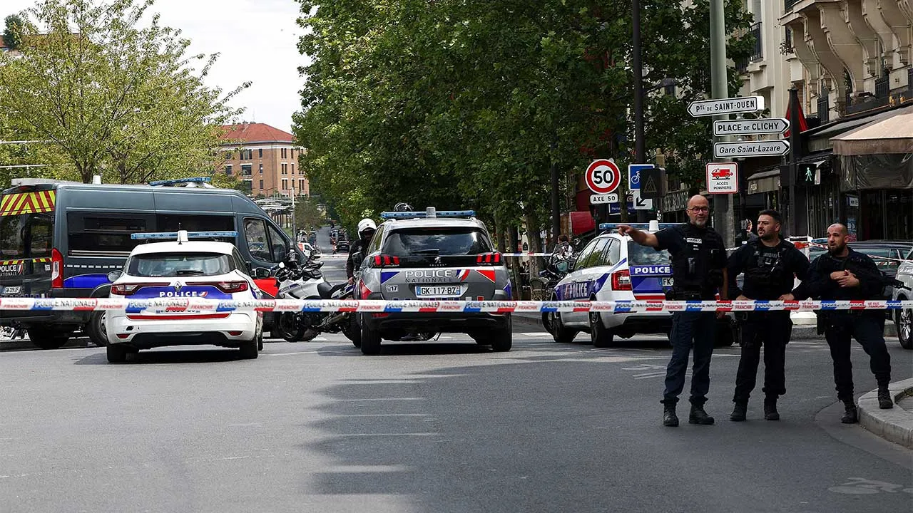 Police stand guard after a knife attack near the Porte de Clichy in Paris, France July 27, 2026. REUTERS/Abdul Saboor