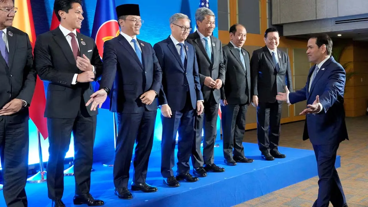 U.S. Secretary of State Marco Rubio gestures as he arrives for a group photo session, while Cambodia's Foreign Minister Prak Sokhonn, Brunei's Foreign Minister Prince Abdul Maseen Bolkiah, Indonesia's Foreign Minister Sugiono, Laos Foreign Minister Thongsavanh Phomvihane, Malaysian Minister of Foreign Affairs Mohamad Hasan, Myanmar's Permanent Secretary of the Ministry of Foreign Affairs Hau Khan Sum and ASEAN Secretary-General Kao Kim Hourn react during the ASEAN Post Ministerial Conference with the United