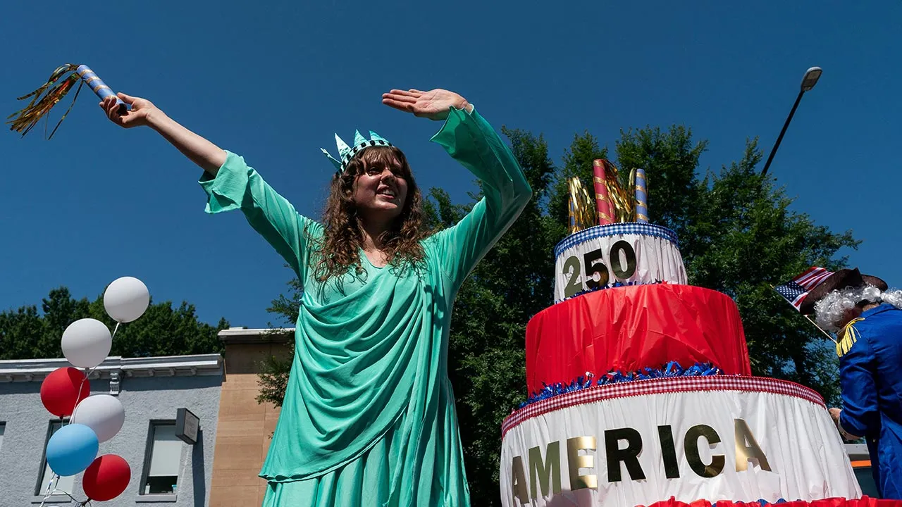 A woman dressed as the Statue of Liberty waves from a float with a 250th birthday cake during the Capitol Hill Community 4th of July Parade marking the 250th anniversary of U.S. Independence, in Washington, D.C., U.S., July 4, 2026. REUTERS/Elizabeth Frantz
