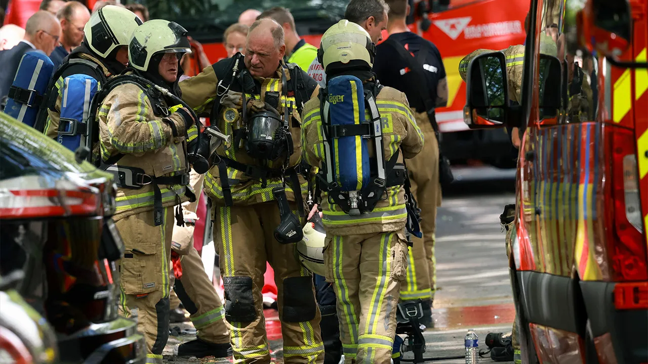 Firefighters work at the site of a fire in a housing building in Antwerp, Belgium, July 1, 2026. REUTERS/Yves Herman