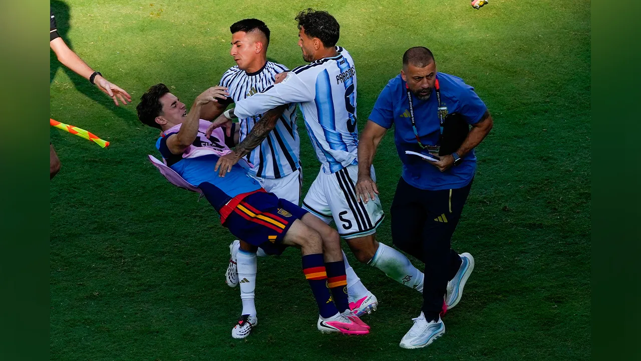 Spain's Gavi, left, falls as he scuffles with Argentina's Leandro Paredes (5) and Thiago Almada during the World Cup final soccer match between Spain and Argentina in East Rutherford, N.J., near New York, Sunday, July 19, 2026. (AP Photo/Yuki Iwamura)