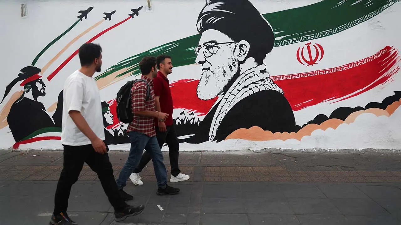 People walk past a mural with a picture of Iran's late Supreme Leader Ayatollah Ali Khamenei, ahead of his farewell ceremony, in Tehran, Iran, July 1, 2026. Majid Asgaripour/WANA (West Asia News Agency) via REUTERS ATTENTION EDITORS - THIS PICTURE WAS PROVIDED BY A THIRD PARTY. ISRAEL OUT. NO COMMERCIAL OR EDITORIAL SALES IN ISRAEL. NO ACCESS FOR ISRAELI MEDIA. NO USE BBC PERSIAN. NO USE VOA PERSIAN. NO USE MANOTO. NO USE IRAN INTERNATIONAL. NO USE RADIO FARDA. DIGITAL: NO USE BBC PERSIAN. NO USE VOA PERSIA