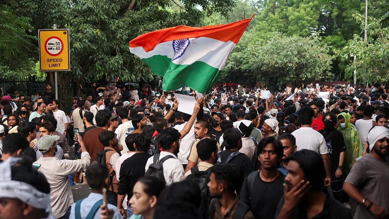 A supporter of India's Cockroach Janata Party (CJP) holds an Indian national flag at the ongoing protest site, a few days after thousands of protesters marched towards parliament demanding the resignation of Education Minister Dharmendra Pradhan over National Eligibility cum Entrance Test (NEET) examination paper leaks, at Jantar Mantar in New Delhi, India, July 23, 2026. REUTERS/Francis Mascarenhas