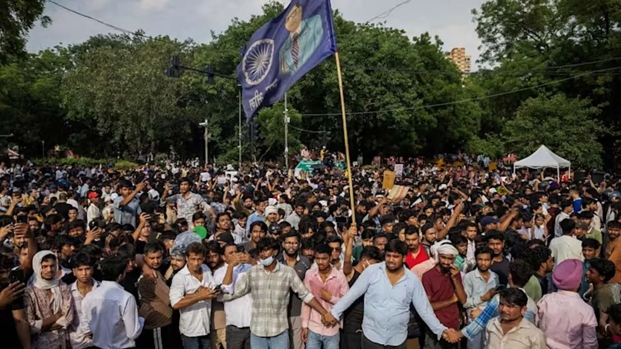 Supporters of India's Cockroach Janata Party (CJP) form a human chain to control demonstrators during the ongoing protests, two days after thousands of protesters marched towards parliament demanding the resignation of Education Minister Dharmendra Pradhan over examination paper leaks, at Jantar Mantar in New Delhi, India, on Jul 22, 2026. (Photo: Reuters/Adnan Abidi)