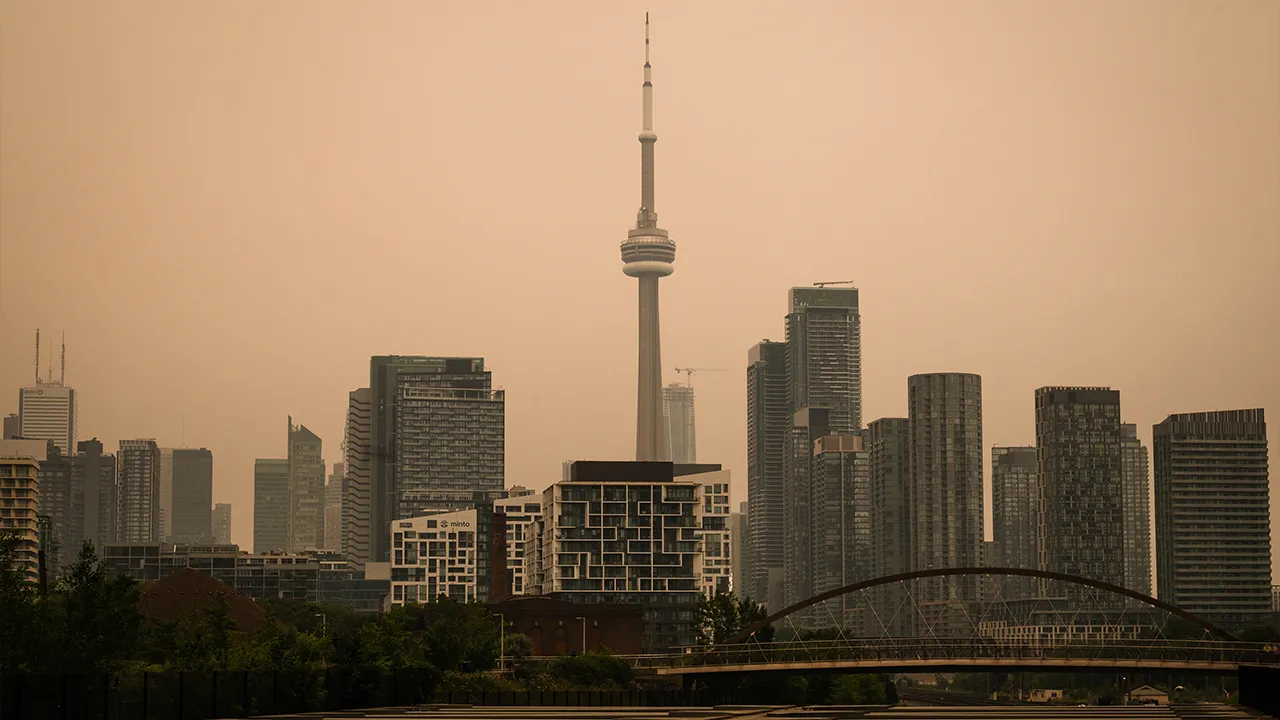The CN Tower is pictured in Toronto as wildfire smoke fills the city, on Wednesday, July 15, 2026. (Laura Proctor/The Canadian Press via AP)
