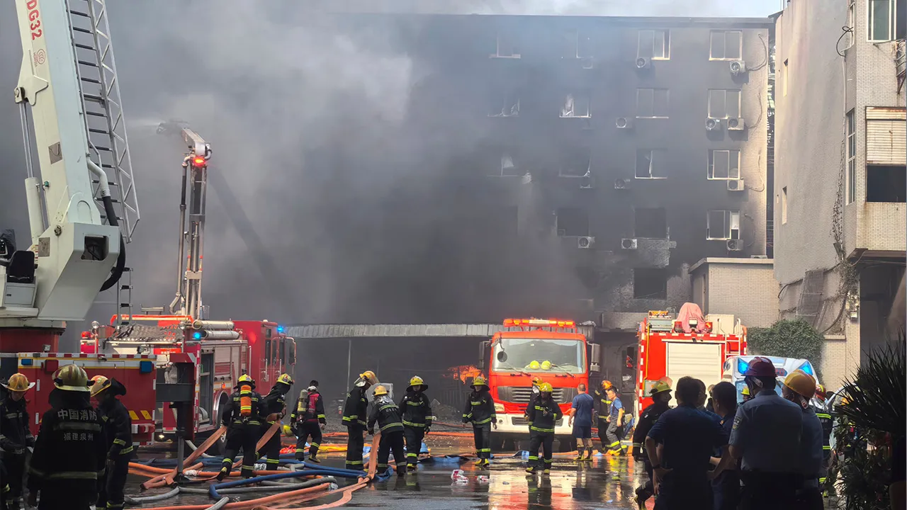 In this photo released by Xinhua News Agency, firefighters at the scene of a footwear factory fire in Jiangtou village, Chendai township of Jinjiang city, southeastern China's Fujian province, Thursday, July 9, 2026. (Zheng Liang/Xinhua via AP)