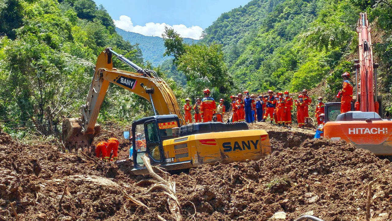 In this photo released by Xinhua News Agency, rescuers conduct search and rescue at the site of a landslide at a village in Nanhe township of Tanchang County, Longnan City, northwest China's Gansu Province on Tuesday, July 7, 2026. (Xinhua via AP)