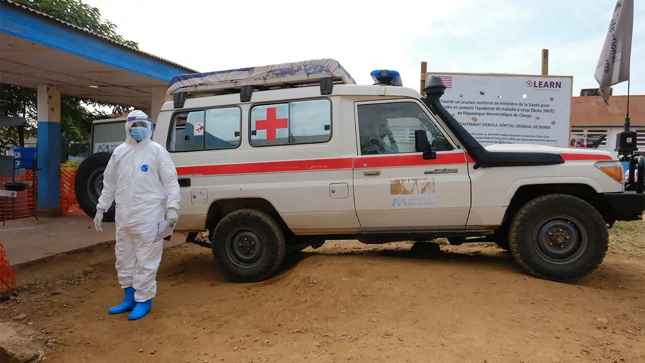 FILE PHOTO: A doctor wearing personal protective equipment (PPE) stands near an ambulance at the Ebola Virus Disease Treatment Center at the Bunia General Reference Hospital, one month after cases were confirmed in Bunia, eastern Democratic Republic of Congo, June 15, 2026. REUTERS/Gradel Muyisa Mumbere/File Photo