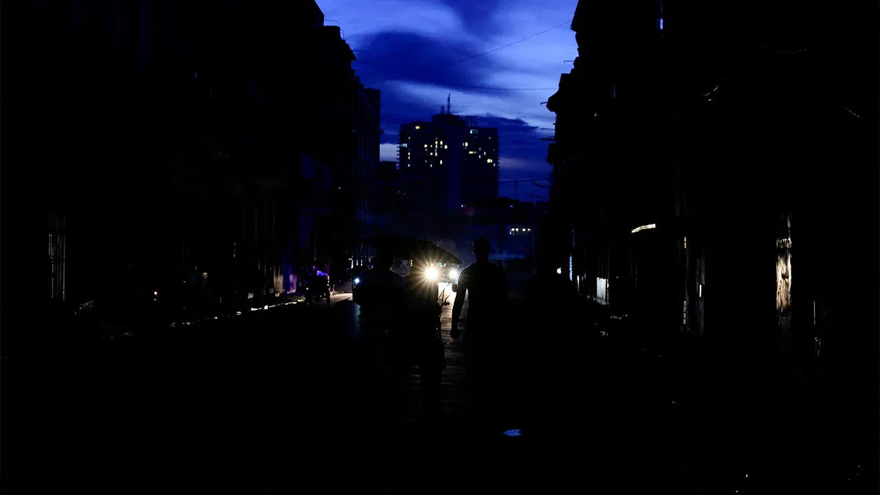 People on a street walk past a bicitaxi as Cuba's national electric grid collapsed at midday, leaving around 10 million people without power, in Havana, Cuba, July 6, 2026. REUTERS