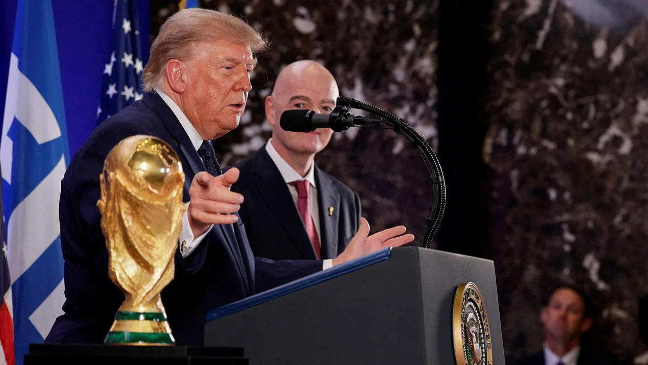 U.S. President Donald Trump, flanked by FIFA President Gianni Infantino, gestures while speaking next to FIFA World Cup Trophy, as they attend a FIFA reception at Trump Tower in New York City, U.S., July 17, 2026. REUTERS/Evan Vucci