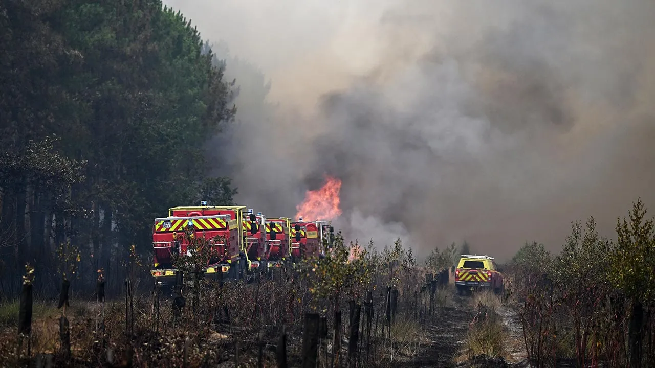 Firefighters tackle a blaze as wildfires rage near Le Las, outside Bordeaux, France, Monday, July 27, 2026. (AP Photo/Emma Da Silva)