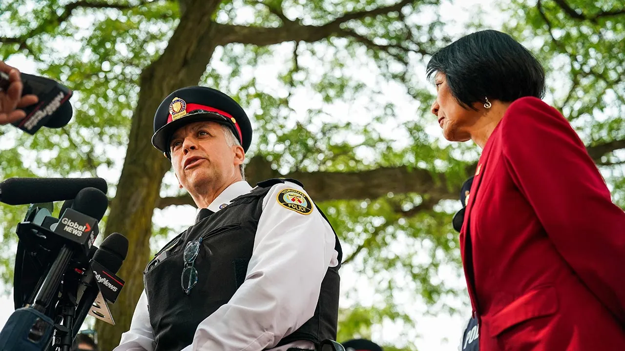 Toronto Police Deputy Chief Frank Barredo speaks as Toronto Mayor Olivia Chow stands beside him during a press conference at the scene of a shooting at the U.S. Consulate in Toronto, Ontario, Canada, July 27, 2026. REUTERS/Arlyn McAdorey