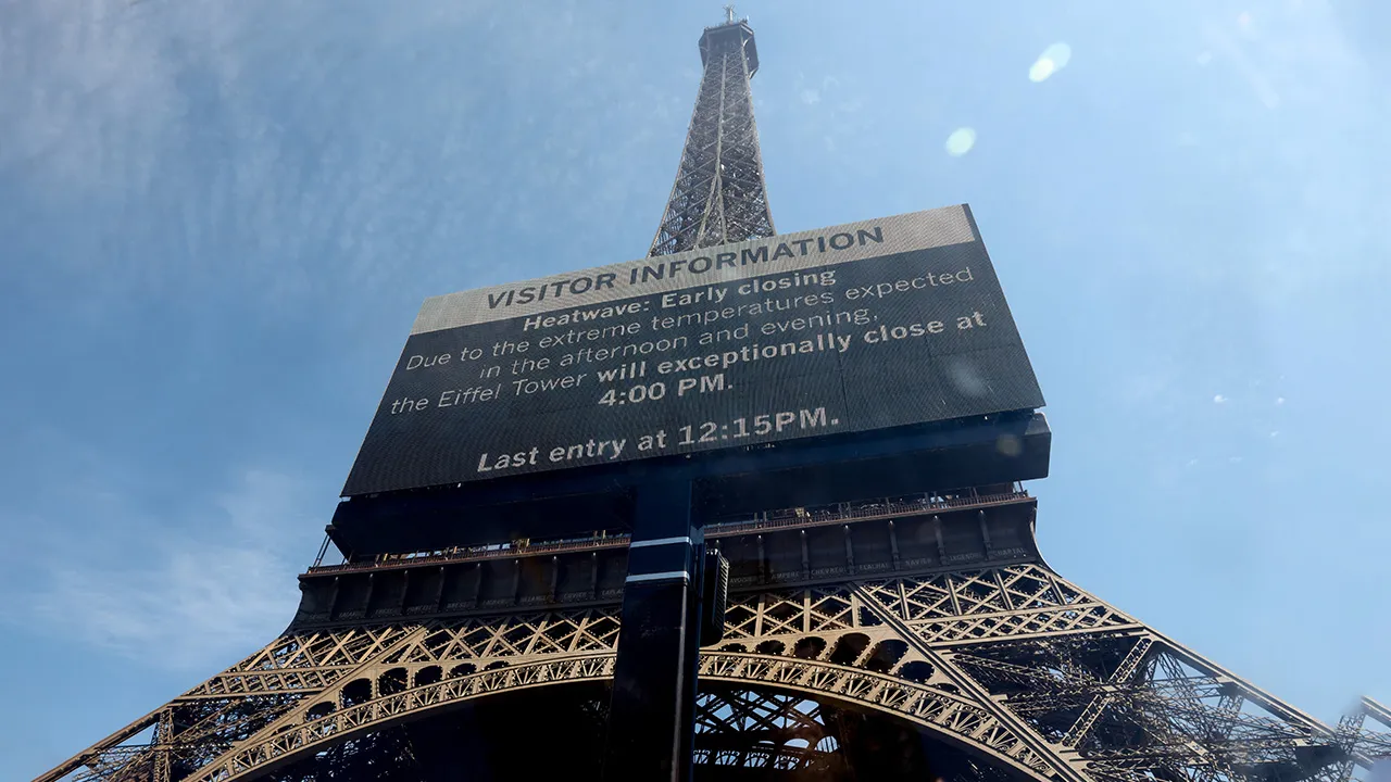 A sign informs visitors that the Eiffel Tower will close at 16:00 CEST today due to extreme temperatures during a heatwave in Paris, France, July 11, 2026. REUTERS/Tom Nicholson