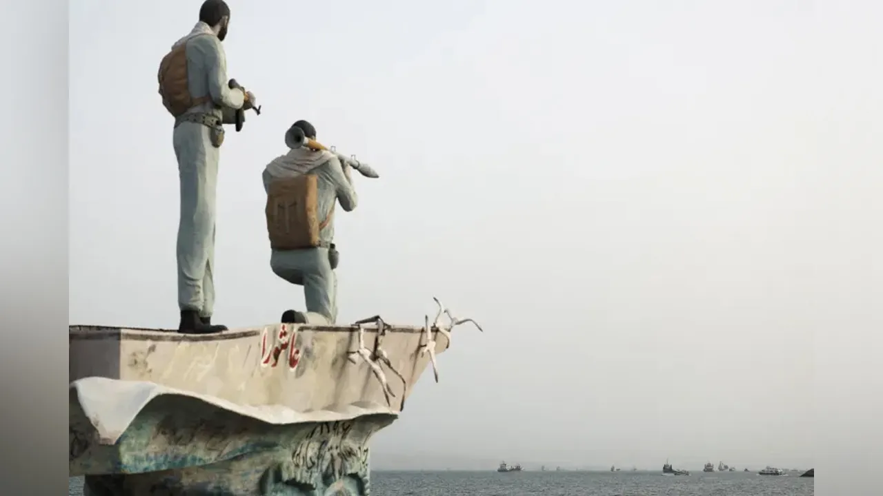 A statue of Iranian military members overlooks vessels navigating the Strait of Hormuz near the beach in Bandar Abbas, Iran, May 22 [File: Majid Asgaripour/WANA via Reuters]