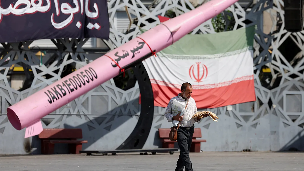 A man walks next to a symbolic mockup of an Iranian missile and an Iranian flag at Imam Hussein Square in Tehran, Iran, July 12, 2026. Majid Asgaripour/WANA (West Asia News Agency) via REUTERS 