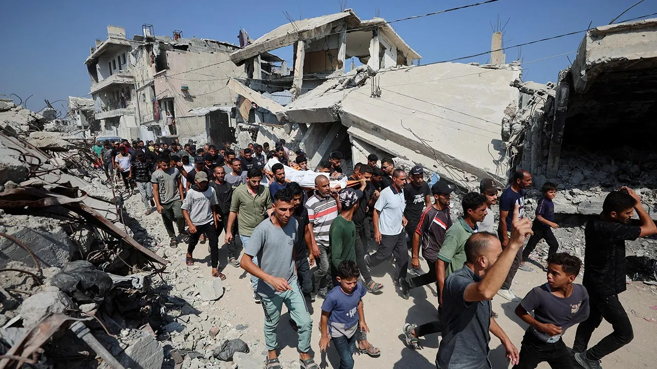 Mourners react while carrying a body during the funeral of three Palestinians, who were killed in an Israeli strike, according to medics, in Gaza City, July 16, 2026. REUTERS/Dawoud Abu Alkas