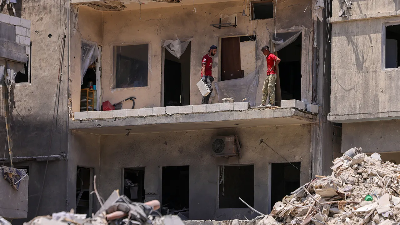 Bricklayers restore a balcony of a building destroyed in an Israeli airstrike to allow the owner's family to return home after displacement during the war, following the Israel-Lebanon deal, in Tyre, southern Lebanon, July 5, 2026. REUTERS