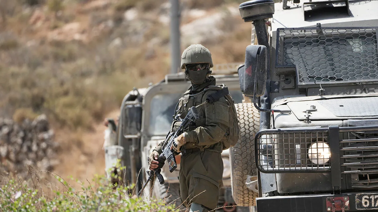 Israeli army units block the road and prevent Palestinian villagers, supported by foreign and Israeli peace activists, from reaching their lands where Israeli settlers established a new outpost, at the West Bank town of Qabalan, southeast of Nablus, Saturday, July 4, 2026. (AP Photo/Majdi Mohammed)
