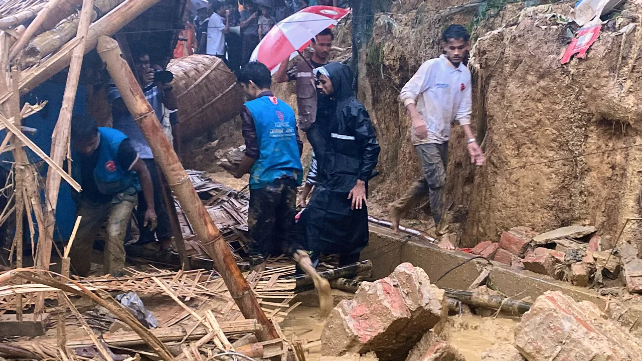Rescuers work at the site of a landslide at a Rohingya refugee camp in Cox's Bazar, Bangladesh, Wednesday, July 8, 2026. (AP Photo/Shamimul Islam Faisal)