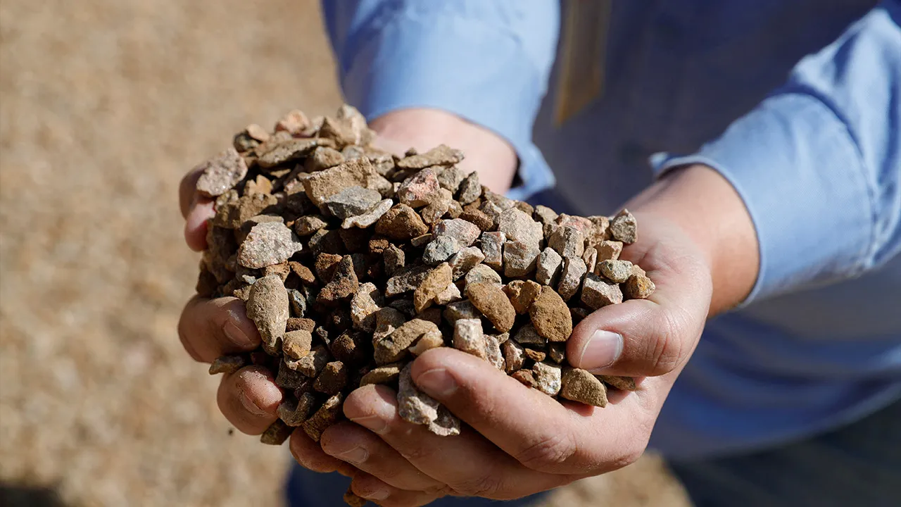 Matt Green, mining/crushing supervisor at MP Materials, displays crushed ore before it is sent to the mill at the MP Materials rare earth mine in Mountain Pass, California, U.S. January 30, 2020. Picture taken January 30, 2020. REUTERS/Steve Marcus