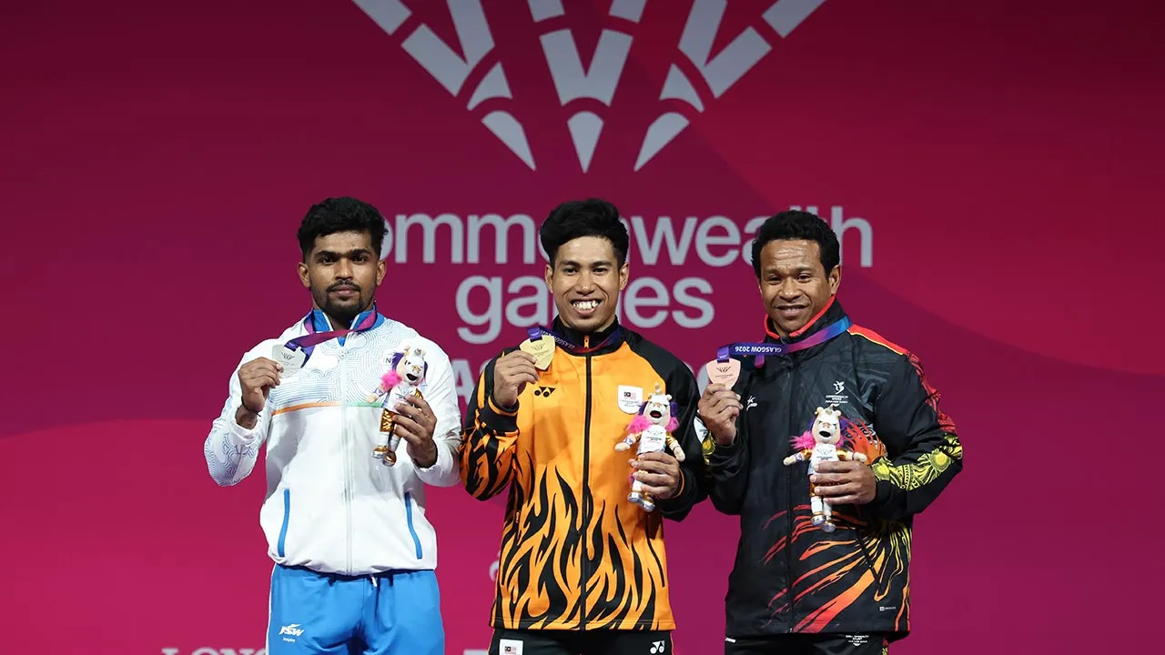 GLASGOW, July 27 -- National weightlifter Muhamad Aznil Bidin with the gold medal he won in the men's 65kg category at the Glasgow 2026 Commonwealth Games held at the Scottish Event Campus (SEC) Armadillo today.  Aznil clinched the gold medal with a combined lift of 299kg, while India's Raja Muthupandi (left) won the silver medal and Papua New Guinea's Baru Morea (right) secured the bronze.  --fotoBERNAMA (2026) COPYRIGHT RESERVED