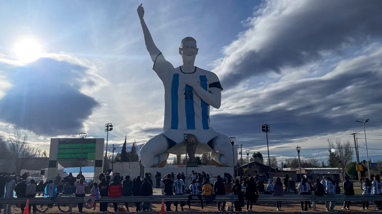 People gather by a statue of Argentina's revered Lionel Messi while watching the World Cup semi-final between Argentina and England, in Cutral Co, in the Patagonian province of Neuquen, Argentina, July 15, 2026. REUTERS/Leila Miller