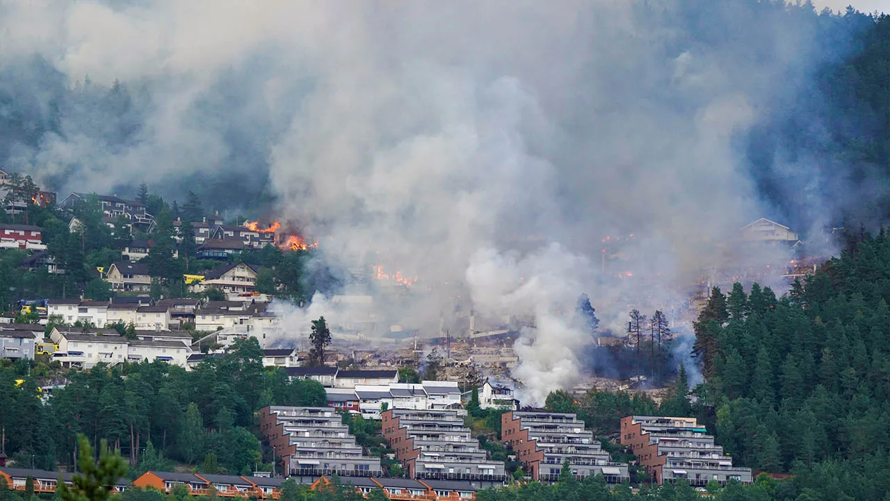 Smoke rises from a large fire that has spread from terraced houses in Krokstadelva, Drammen municipality, Norway, July 17, 2026. More than 50 homes were destroyed by fire on Friday near the city of Drammen in southern Norway as firefighters battled to contain the flames amid strong winds, rescue officials said. Thomas Fure/NTB/via REUTERS