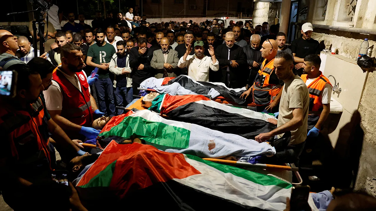 Palestinians pray next to the bodies of Palestinians during their funeral who were killed in a deadly shooting incident, according to Israeli and Palestinian health officials, near the village of Tal, in Nablus, in the Israeli-occupied West Bank, July 25, 2026. REUTERS