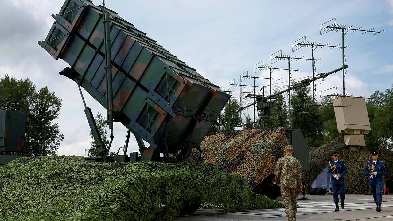 FILE PHOTO: Ukrainian service members walk next to a launcher of a Patriot air defence system, amid Russia's attack on Ukraine, in an undisclosed location, Ukraine August 4, 2024. REUTERS/Valentyn Ogirenko/File Photo