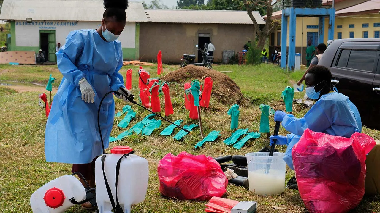 FILE PHOTO: Medical workers dressed in personal protective equipment (PPE) disinfect their equipment at an Ebola treatment centre during a ceremony to present recovery certificates to patients at the Rwambara General Reference Hospital in Bunia, eastern Democratic Republic of Congo, June 16, 2026. REUTERS/Gradel Muyisa Mumbere/File Photo