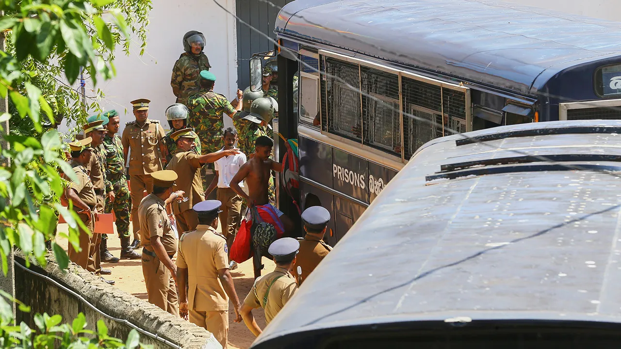 Security personnel escort prisoners to a bus in the compound of a prison where deadly clashes broke out on Sunday, in Negombo, 35 kilometers (22 miles) north of the capital Colombo, Sri Lanka, Monday, July 6, 2026. (AP Photo)