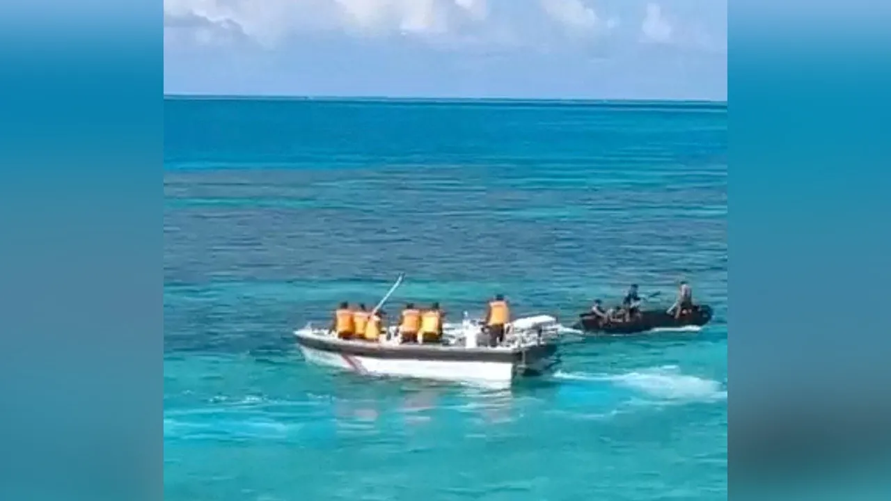 Chinese Coast Guard and Philippine Navy vessels during an encounter at Second Thomas Shoal in the South China Sea July 20, 2026 in this screen grab from handout video. Jay Tarriela via X/Handout via REUTERS THIS IMAGE HAS BEEN SUPPLIED BY A THIRD PARTY. MANDATORY CREDIT. VERIFICATION - Date and location from timestamp from corroborating footage and satellite image. - Paints on the vessel matched file images of China Coast Guard boats. - Man wearing a brown shirt and a hat mat seated in the bow of the darker