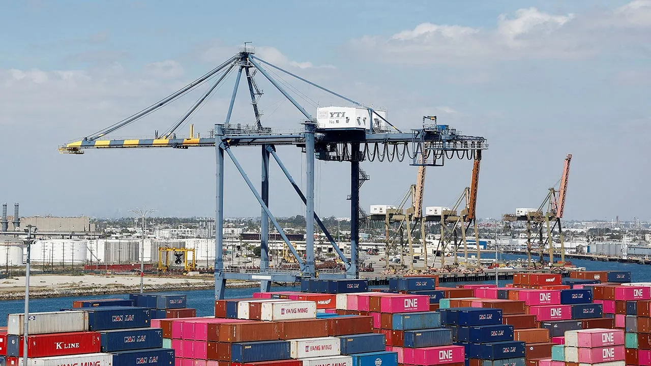 FILE PHOTO: Shipping containers are stacked at a terminal at the port of Los Angeles in Long Beach, California, U.S., March 10, 2026. REUTERS/Caroline Brehman/File Photo