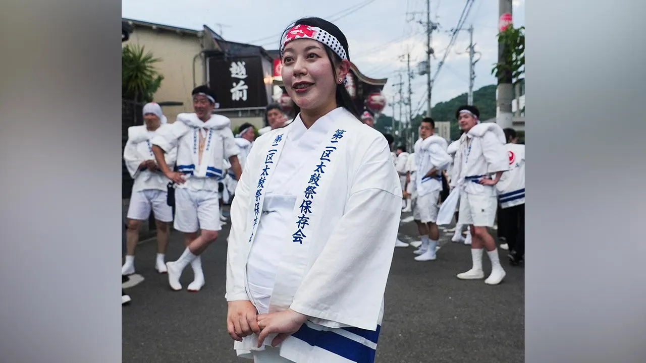 Yawata city mayor, Shoko Kawata, attends a temple procession with residents in Yawata, Kyoto Prefecture, Japan, July 17, 2026. REUTERS/Joseph Campbell