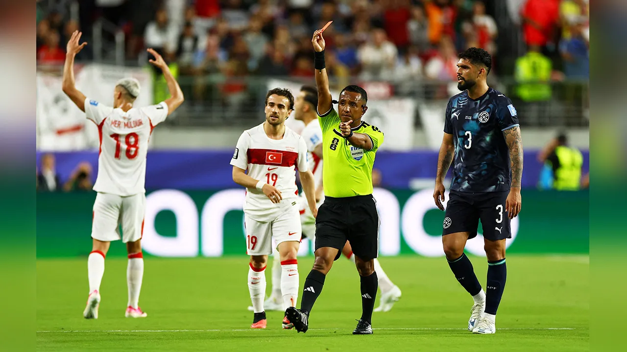 FILE PHOTO: Soccer Football - FIFA World Cup 2026 - Group D - Turkey v Paraguay - San Francisco Bay Area Stadium, Santa Clara, California, U.S. - June 19, 2026 Referee Ivan Barton shows a red card to Paraguay's Miguel Almiron REUTERS/Carlos Barria/File Photo