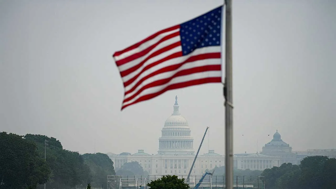The U.S. Capitol and the U.S. flag in smoky conditions due to the Canadian wildfires, in Washington, D.C., U.S., July 17, 2026. REUTERS/Al Drago