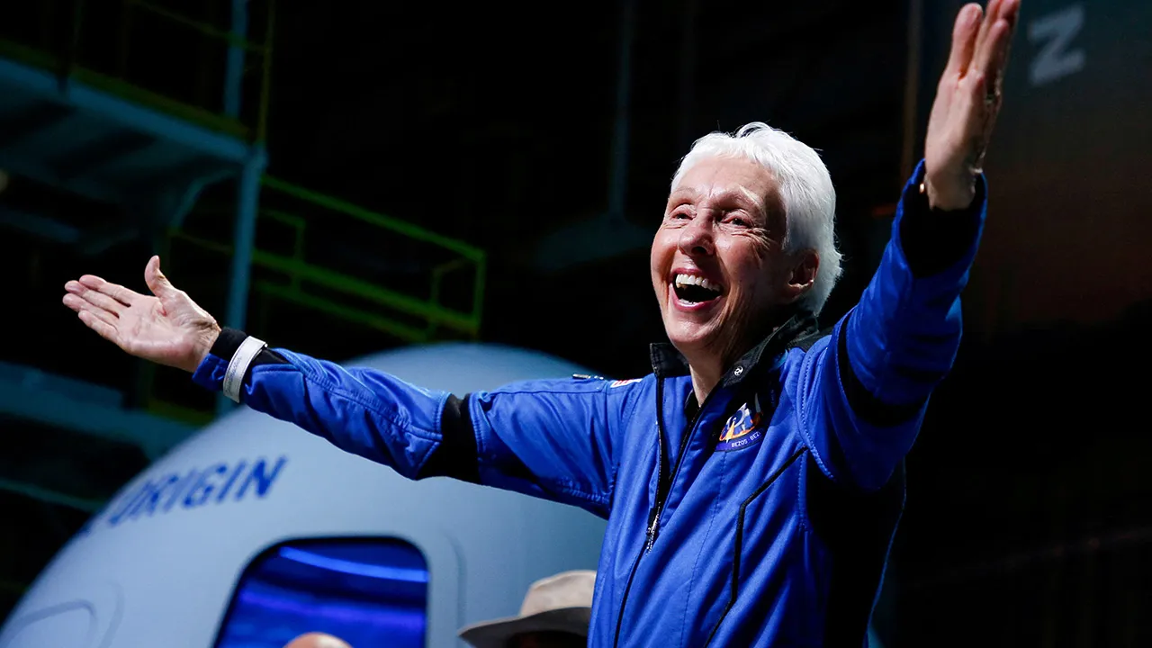 Wally Funk reacts after receiving her astronaut's wings from Blue Origin's Jeff Ashby, a former space shuttle commander at a post-launch press conference after she flew with three crewmates on Blue Origin's inaugural flight to the edge of space, in the nearby town of Van Horn, Texas, U.S., July 20, 2021. REUTERS/Joe Skipper/File Photo