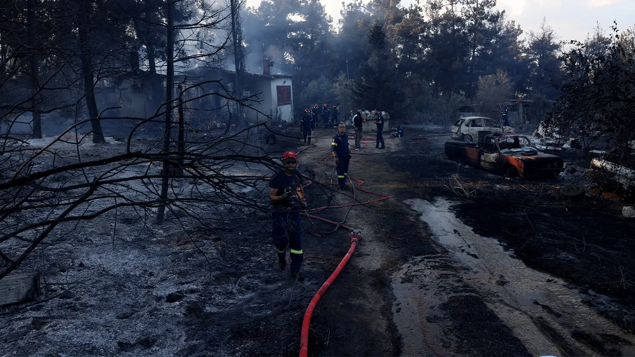 Firefighters try to extinguish a wildfire close to a burnt house near the village of Liti, Thessaloniki, Greece, June 30, 2026. REUTERS/Alexandros Avramidis