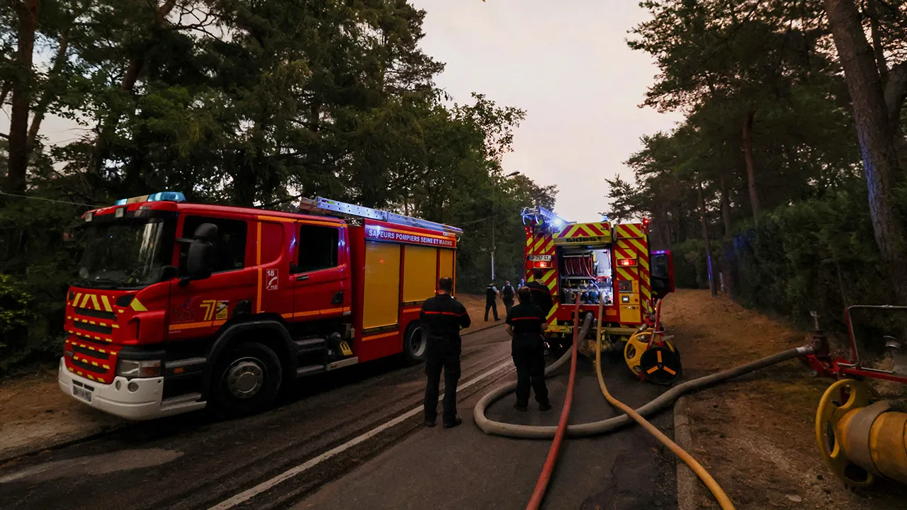 Firefighting crews work to contain wildfires at the Fontainebleau forest, in Acheres-la-Foret, as a heatwave affects large parts of France, July 13, 2026. REUTERS/Stephane Mahe
