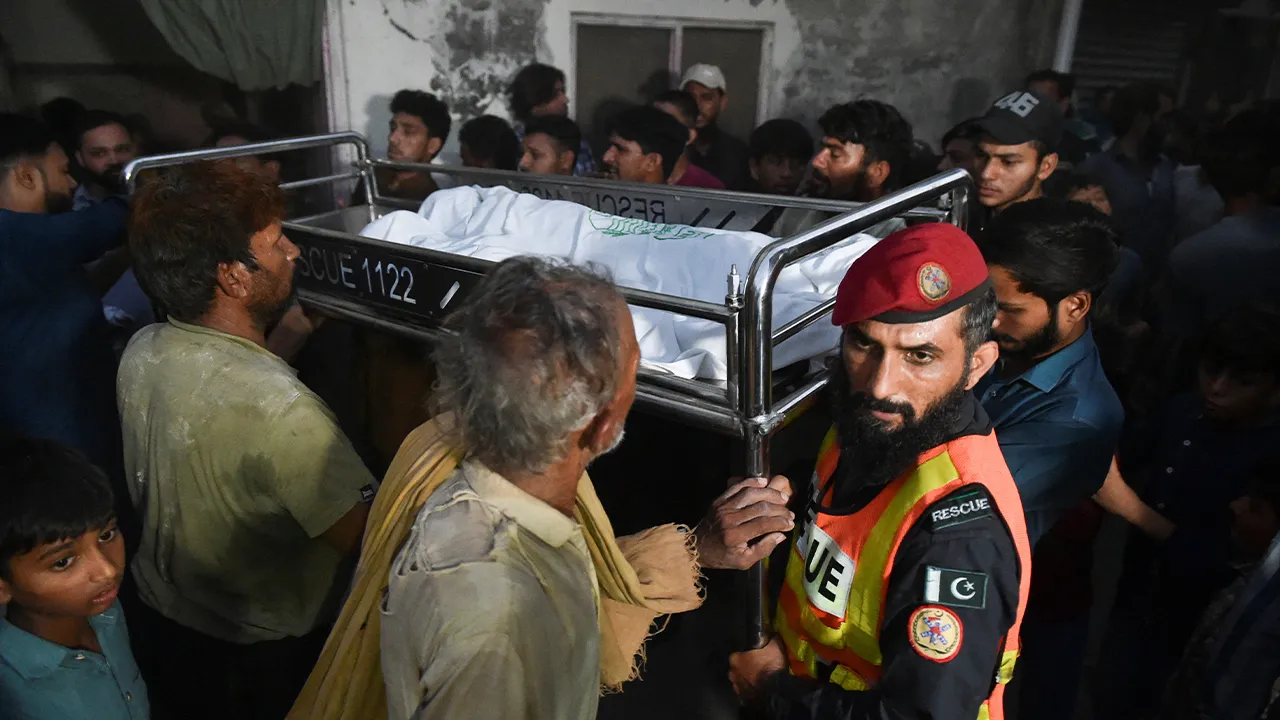 Residents and rescue workers carry a child's body to home, who died after a tuition center roof collapsed, in Lahore, Pakistan, June 30, 2026. REUTERS/Murtaza Ali