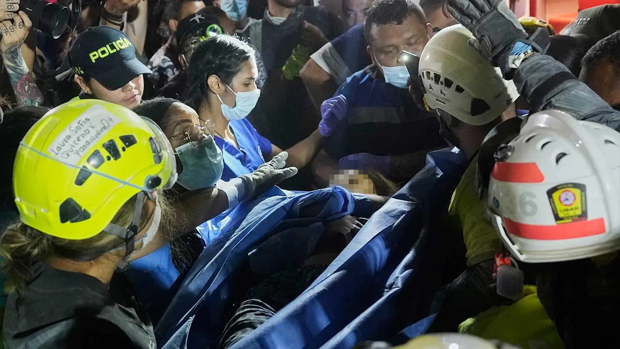 Rescue workers carry a survivor Daniela Largo after pulling her from the rubble the day after an earthquake struck Pereira, Colombia, Tuesday, Aug. 11, 2026. (AP Photo/Fernando Vergara)
