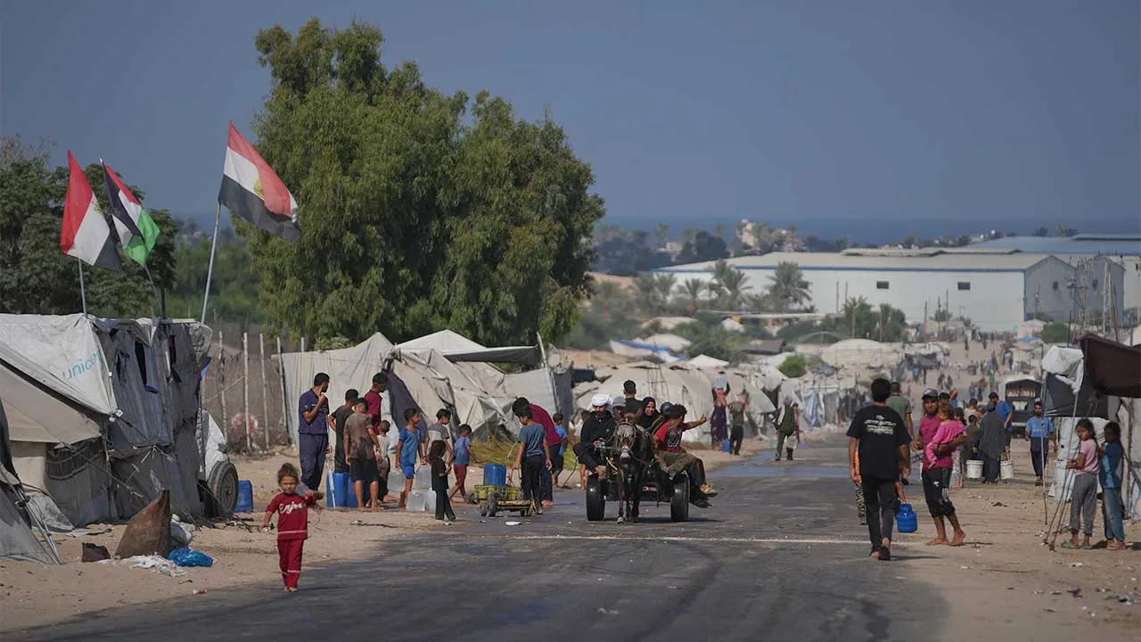 Palestinians go about their daily activities at a makeshift camp for displaced people in Deir al-Balah, central Gaza Strip, Friday, Aug. 7, 2026. (AP Photo/Abdel Kareem Hana)