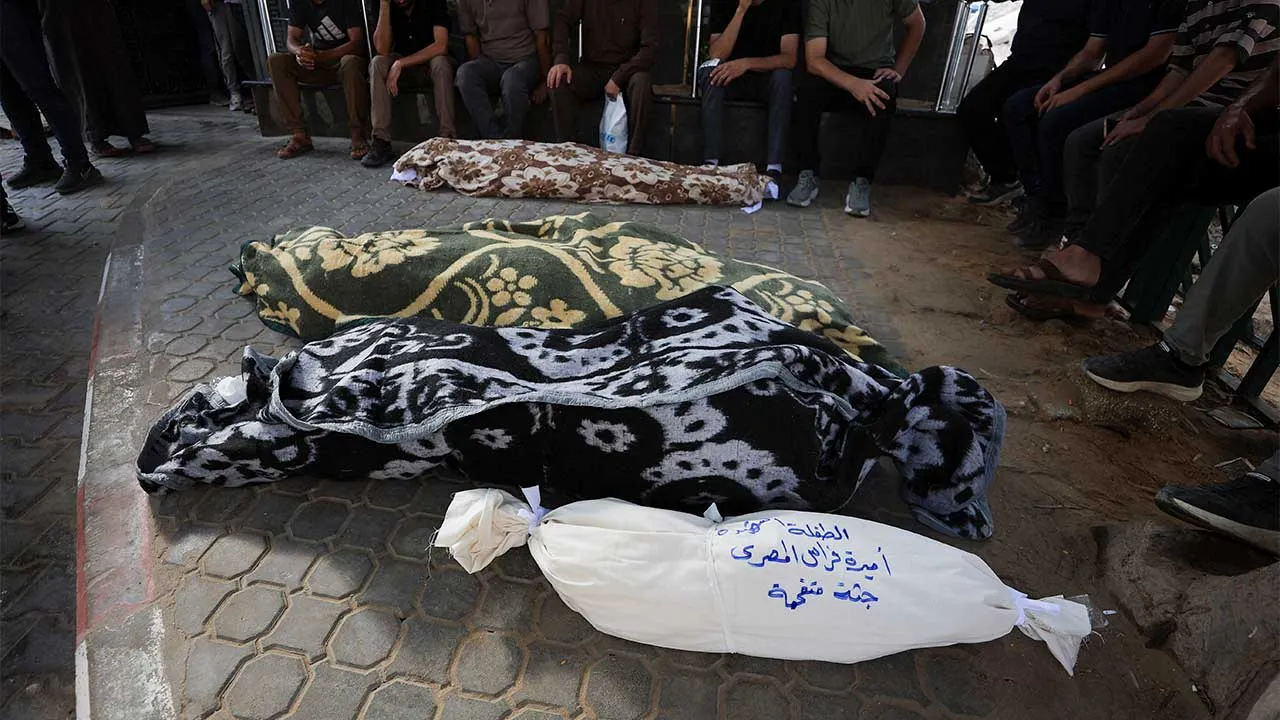 People gather near the bodies of the members of the al-Masri family, on the day of the funeral of six members of the family who were killed after an Israeli strike hit their apartment, according to the Health Ministry, in Gaza City, July 21, 2026. REUTERS/Dawoud Abu Alkas
