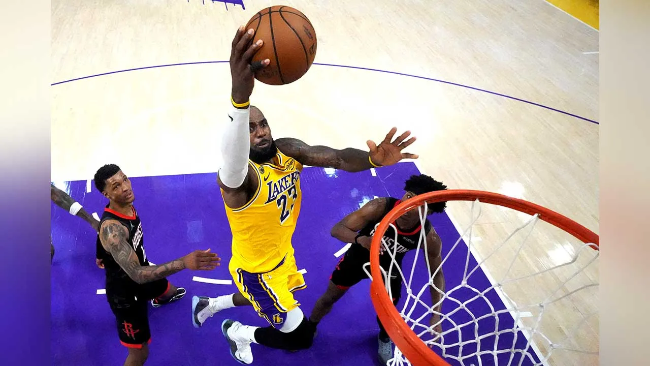 FILE PHOTO: Apr 18, 2026; Los Angeles, California, USA; Los Angeles Lakers forward LeBron James (23) shoots the ball against Houston Rockets forward Jabari Smith Jr. (10) and guard Amen Thompson (1) in the second half during game one of the first round of the 2026 NBA Playoffs at Crypto.com Arena. Mandatory Credit: Kirby Lee-Imagn Images/File Photo
