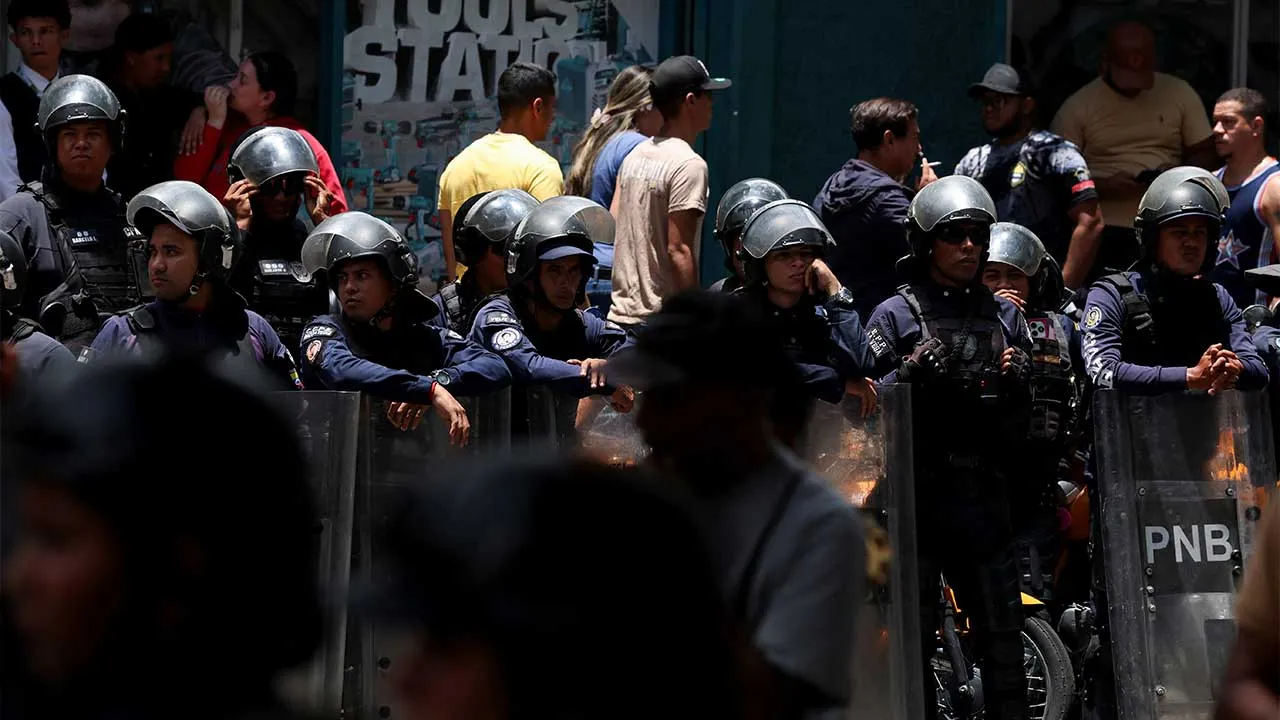 National Bolivarian Police personnel stand outside the Melia Caracas hotel during a protest by public workers, retirees, and pensioners, as the national dialogue talks take place inside, in Caracas, Venezuela, August 12, 2026. REUTERS/Leonardo Fernandez Viloria